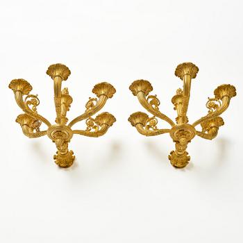 A pair of French Empire six-branch ormolu appliques, ca 1820's.