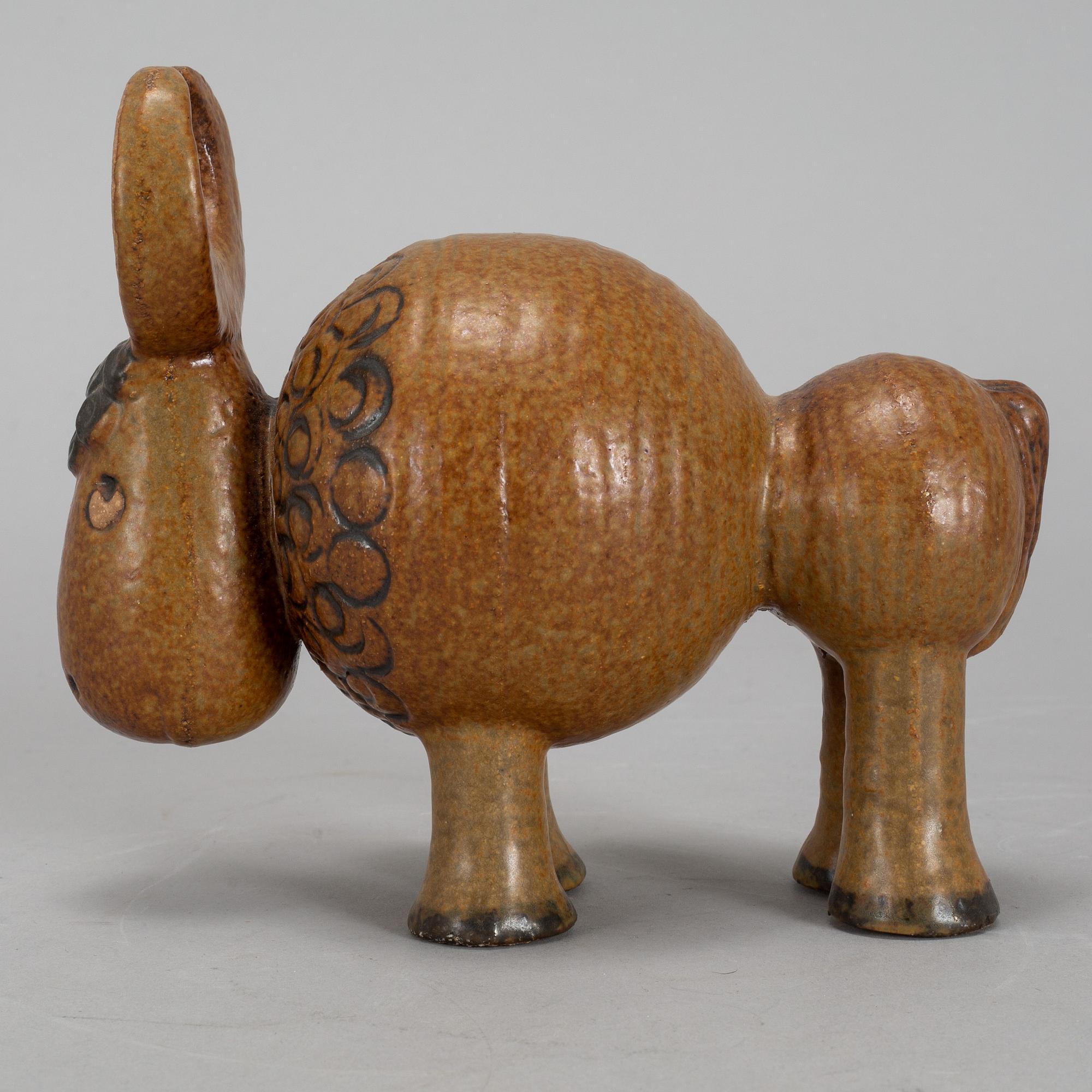 LISA LARSON, a stoneware candelabra and a figurine. Gustavsberg.