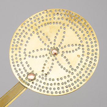 An 18th century brass strainer.