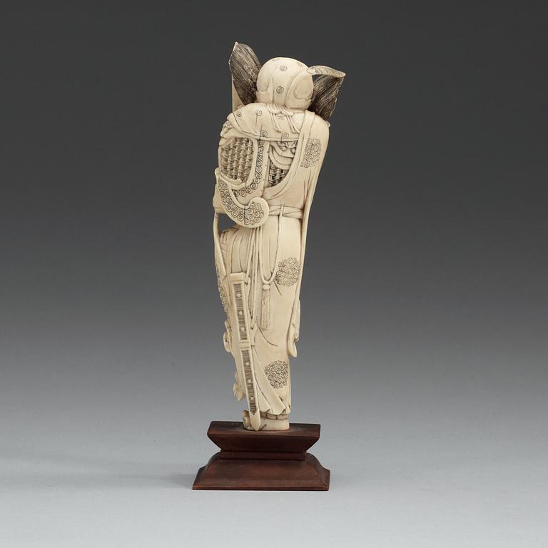 An carved ivory sculpture of a guardsman, China, early 20th Century.