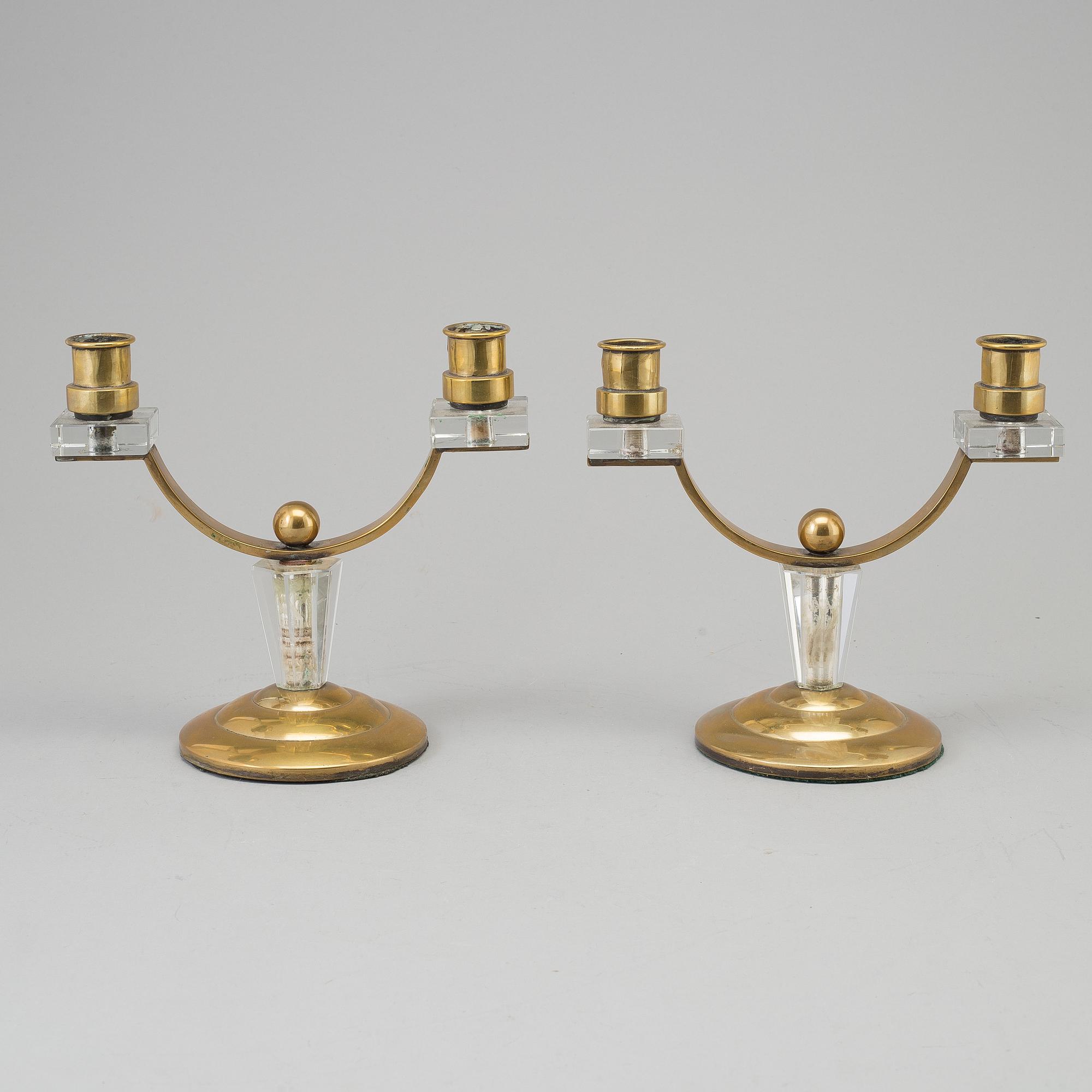 A pair of art déco brass and glass candelabra.