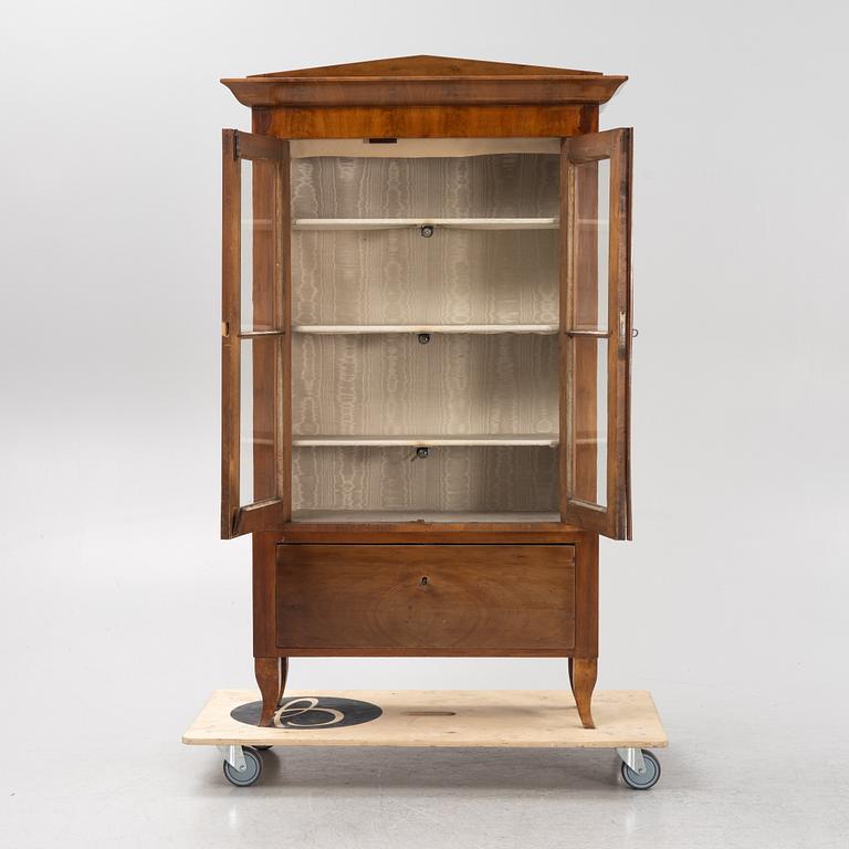A mahogany veneered book cabinet. 19th Century.