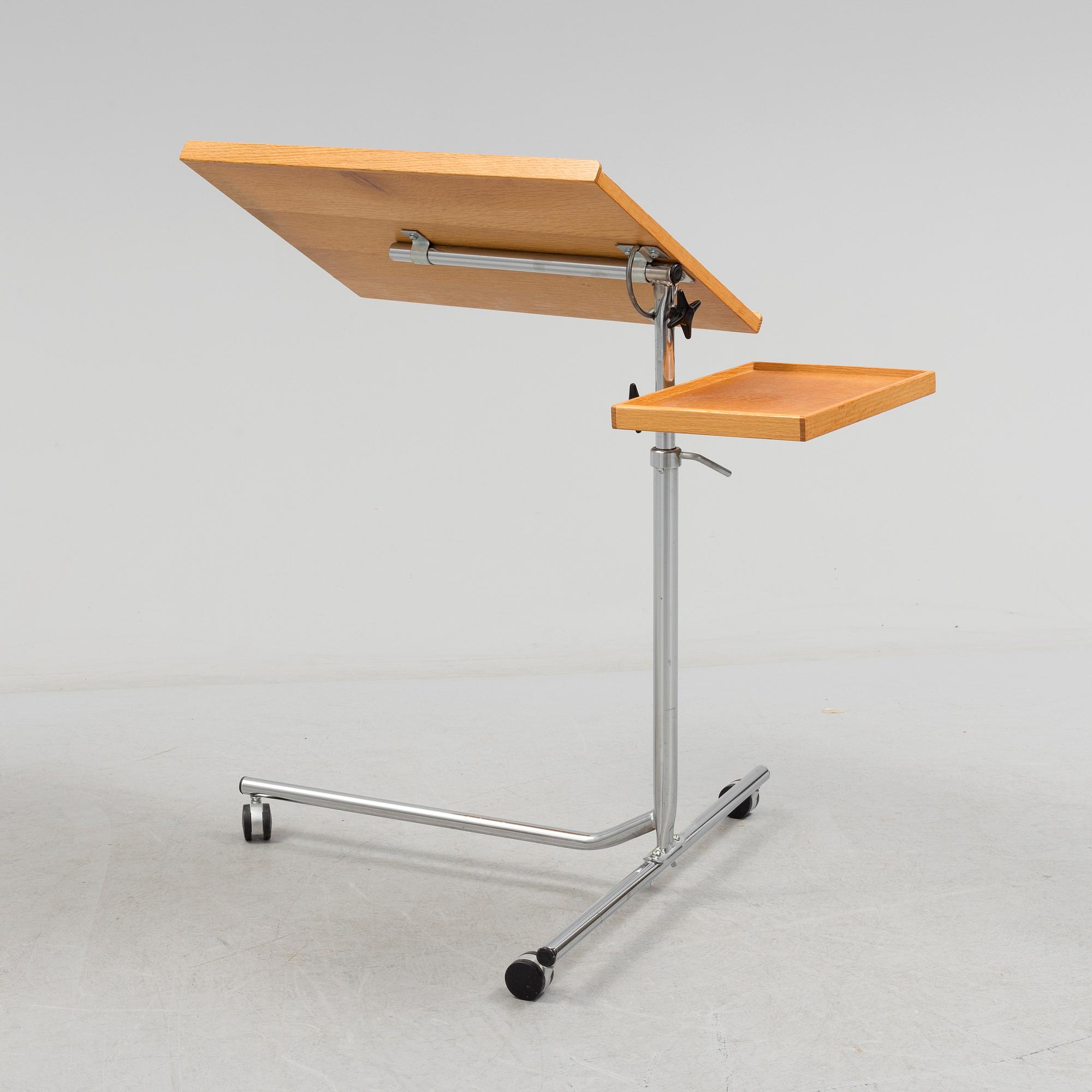 A teak reading table, second half of the 20th Century.