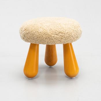 A contemporary stool with birch legs and new sheepskin upholstery.