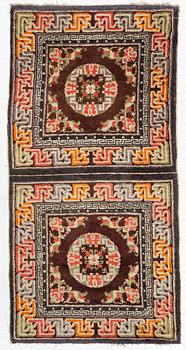 A Chinese two square rug, antique, c. 142 x 71 cm.