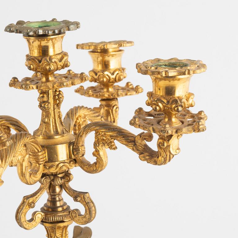 A pair of five-branch gilt and patinated bronze figural candelabra, later part of the 19th century.