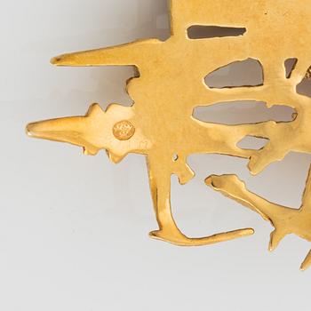An 18K gold brooch set with faceted rubies.