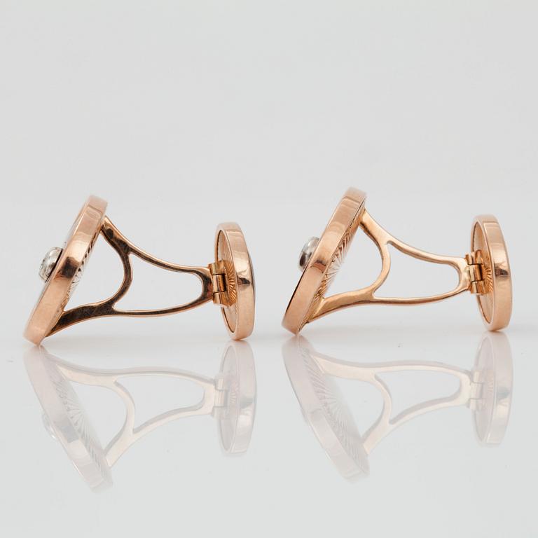 A pair of cufflinks, red enamel and brilliant cut diamond.