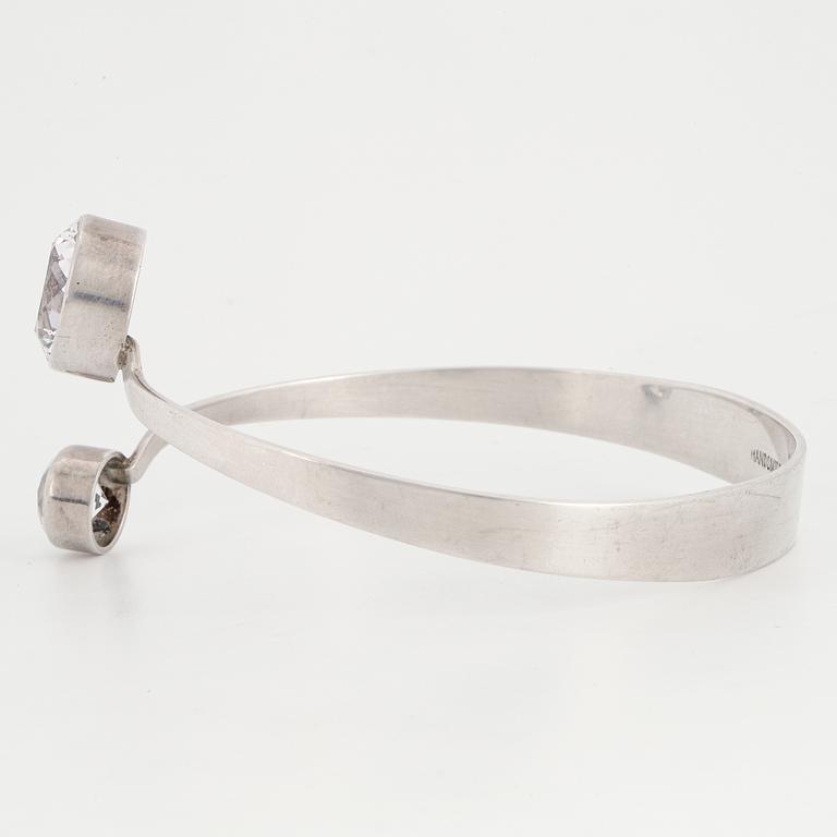 GERT THYSELL, a silver and synthetic white spinel bangle, Gussi, Malmö, 1973.