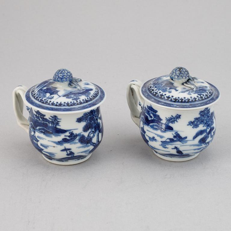 A set of six blue and white custard cups with covers,