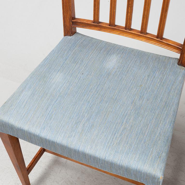 A mahogany table and 12 chairs, first half 20th Century.