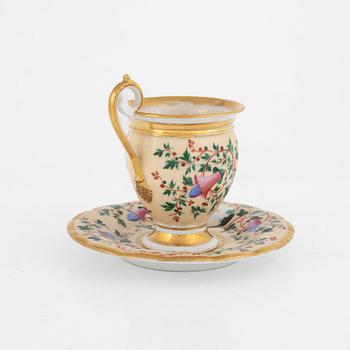 Two Empire porcelain cups with stands, 19th century.