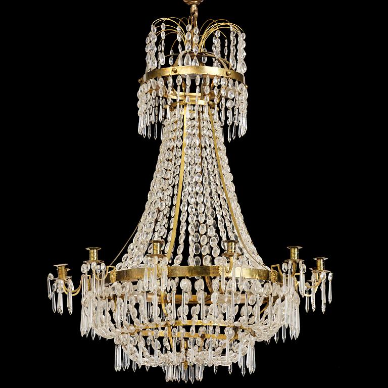 A Swedish gilt brass and cut glass thirteen-light Empire chandelier, early 19th century.