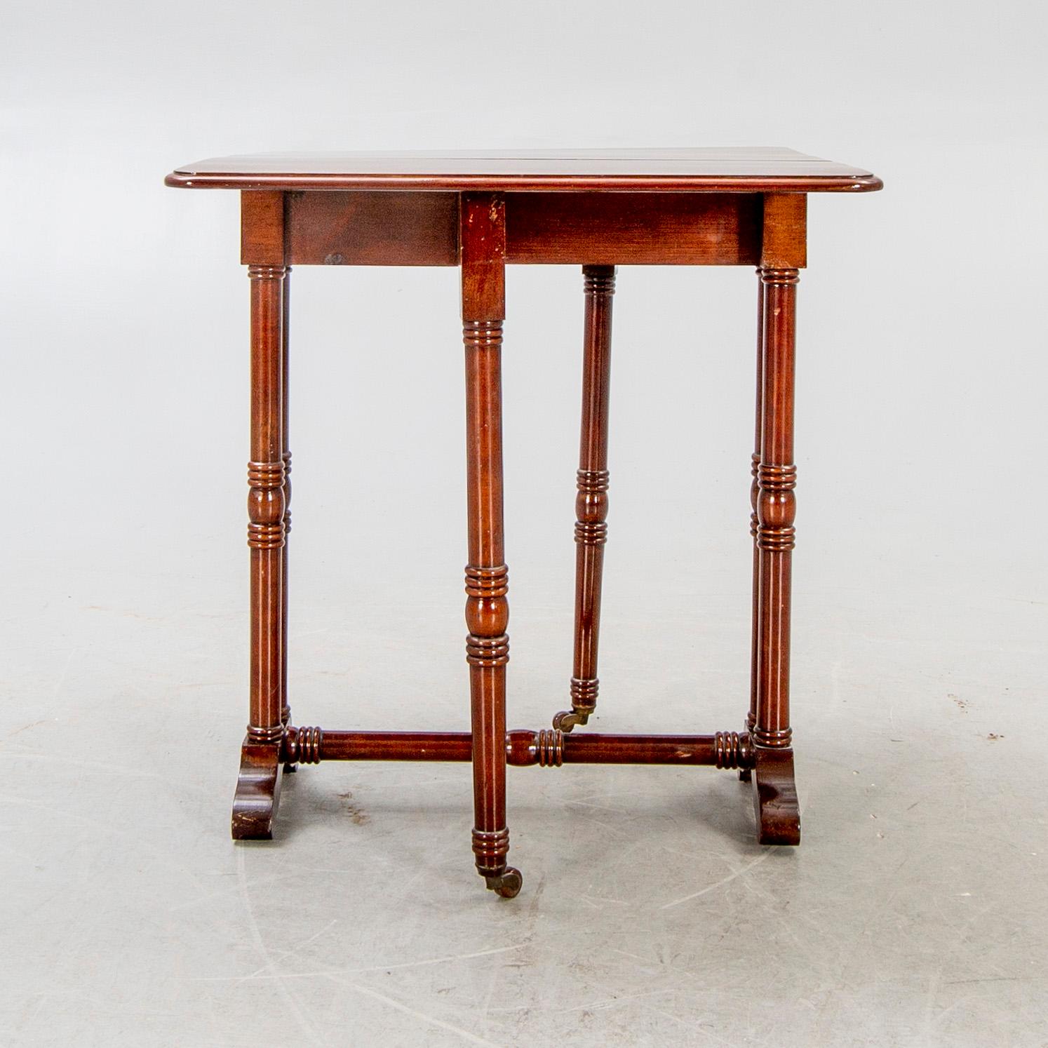 A 20th century English mahogany folding table.