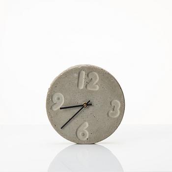 Stina Lindholm, a contemporary concrete planter 'Spira', a concrete flower pot and a wall clock.