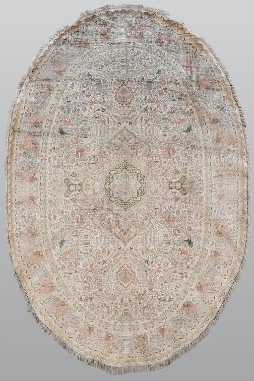 A figural Oriental silk carpet, approx. 273 x 180 cm.