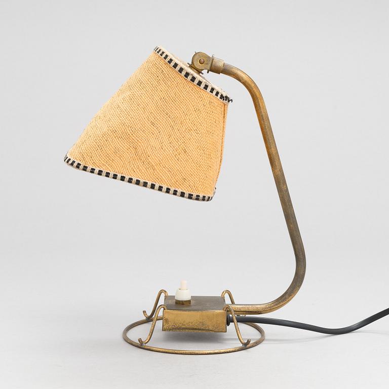 A mid-20th-century table lamp
/wall light for Idman.