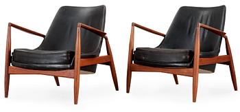 A pair of Ib Kofod Larsen 'Sälen' teak and black leather easy chairs by Olof Person, Jönköping, Sweden.