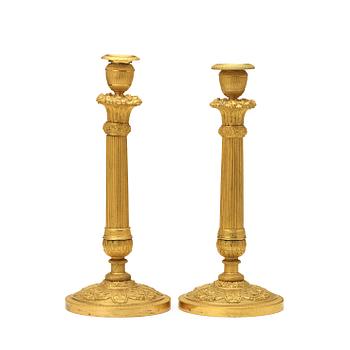 1263. A pair of Empire early 19th century candlesticks.