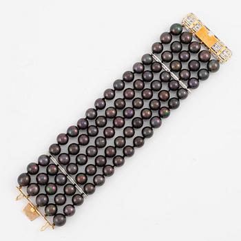 Bracelet with five rows of cultured black pearls, clasp in 18K gold and white gold set with brilliant-cut diamonds.