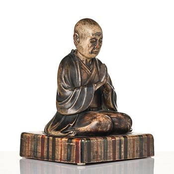A painted and lacquered wooden sculpture of a monk, Japan, 19th century.