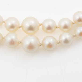 Double-row necklace with graduated cultured pearls, silver clasp set with paste stones.
