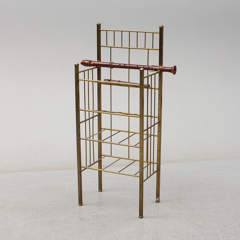 A brass shelf and two flutes, 20th century.