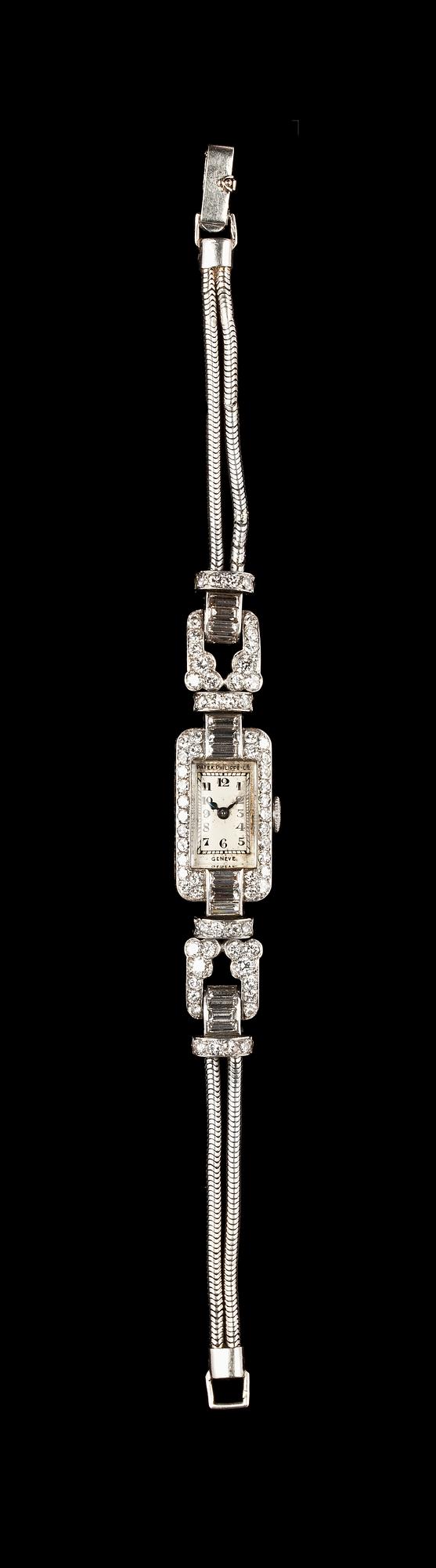 A Patek Philippe ladie's wrist watch, set with baguette- and brilliant cut diamonds, tot. app. 4 cts.