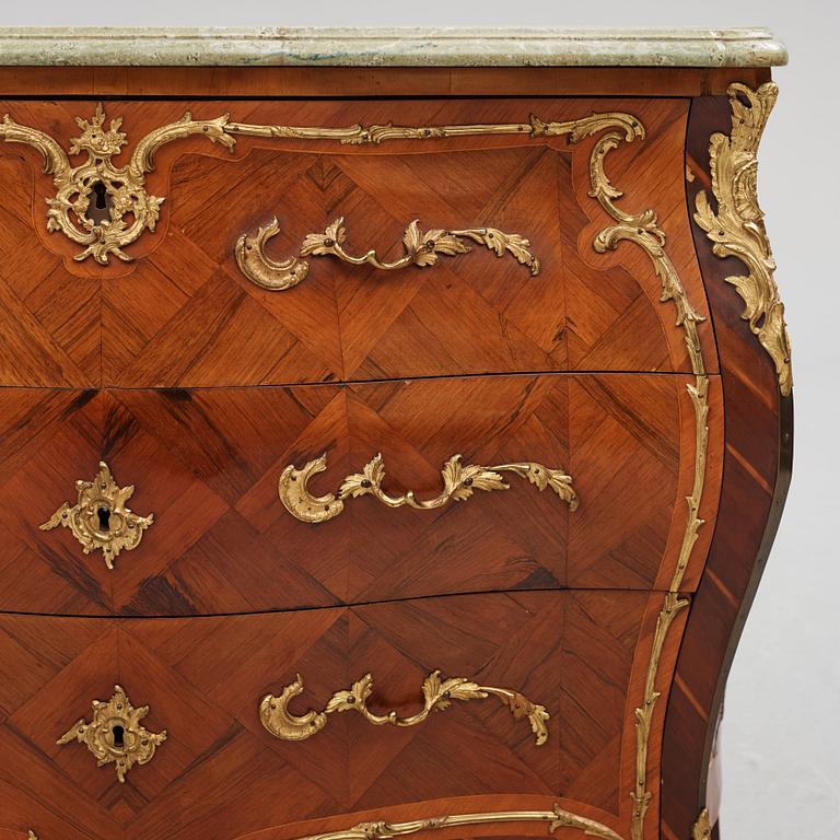 A rococo parquetry and ormolu-mounted commode attributed to L. Nordin (master 1743-1773).