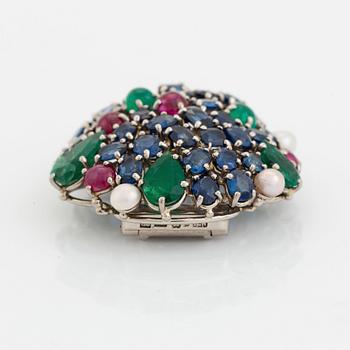 An 18K gold Carlman brooch set with sapphires, emeralds, rubies and pearls.