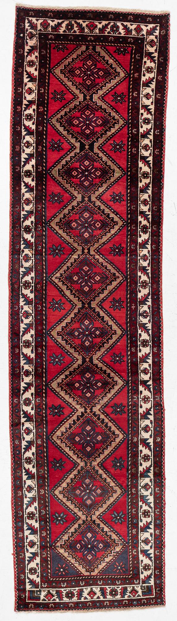 An oriental runner, c. 395 x 100 cm.