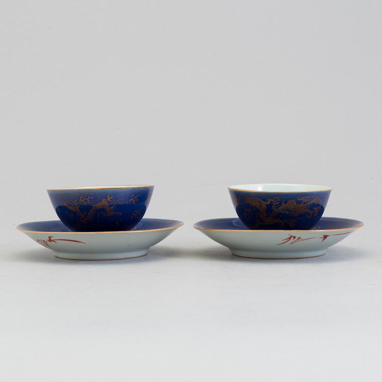 A pair of Chinese powder blue porcelain cups with dishes, Qing dynasty, Qianlong (1736-95), with Qianlongs mark.