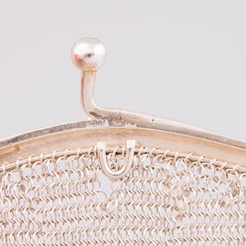 Two silver evening bags and a silver mirror, 1920s-1940s.