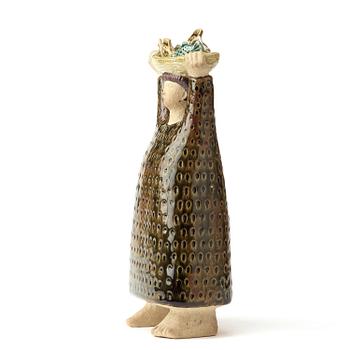 A stig Lindberg stoneware sculpture av woman carrying a a basket of fish, Gustavsberg studio, Sweden probably 1960's.