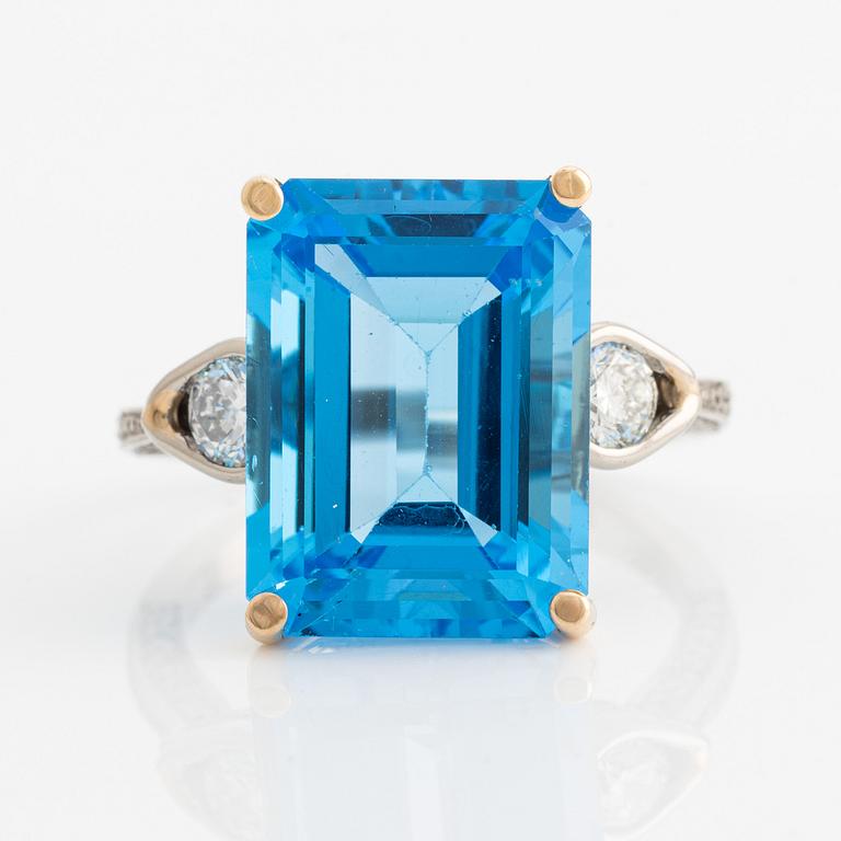 Ring, cocktail ring with large blue topaz and brilliant-cut diamonds.