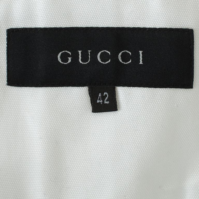 GUCCI, a white jacket.