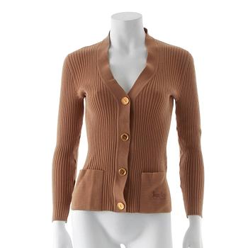 CÉLINE, a beige cardigan.