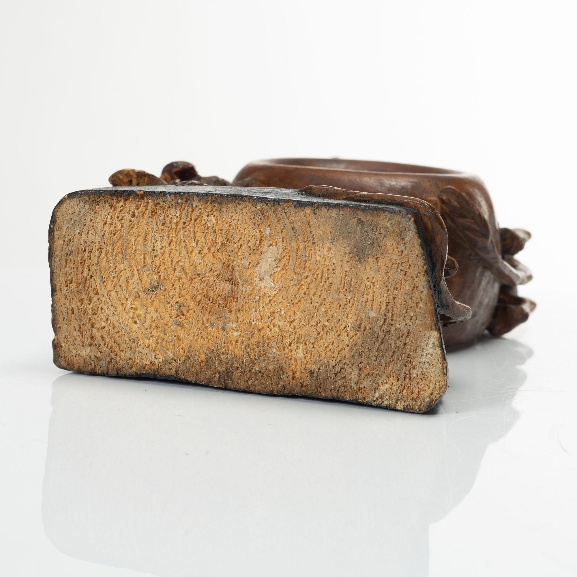 A carved pocket watch stand, Sweden, 19th century.