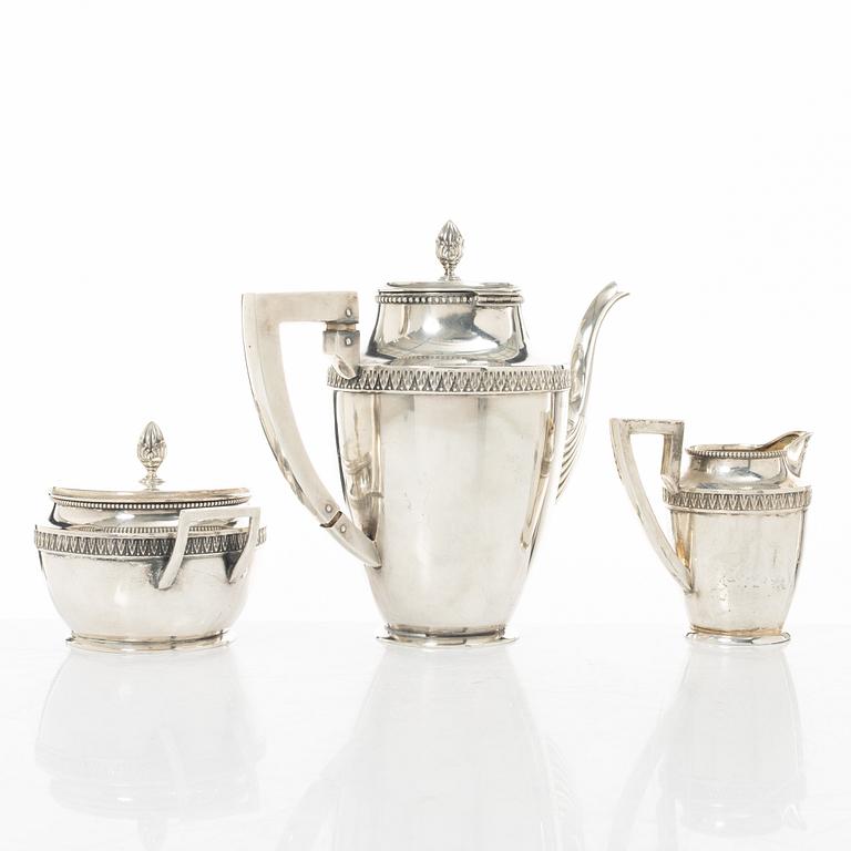 A silver coffee pot, creamer and sugar bowl, import marks of Axel Larson, Helsingborg 1920.
