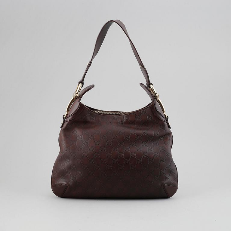 Gucci, a leather bag.