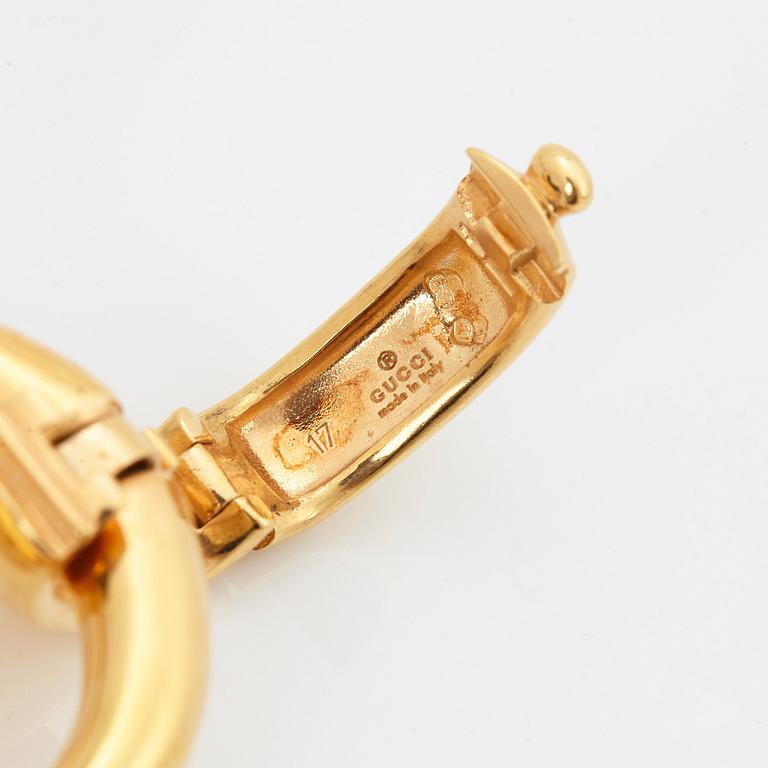 An 18K gold Gucci bracelet.