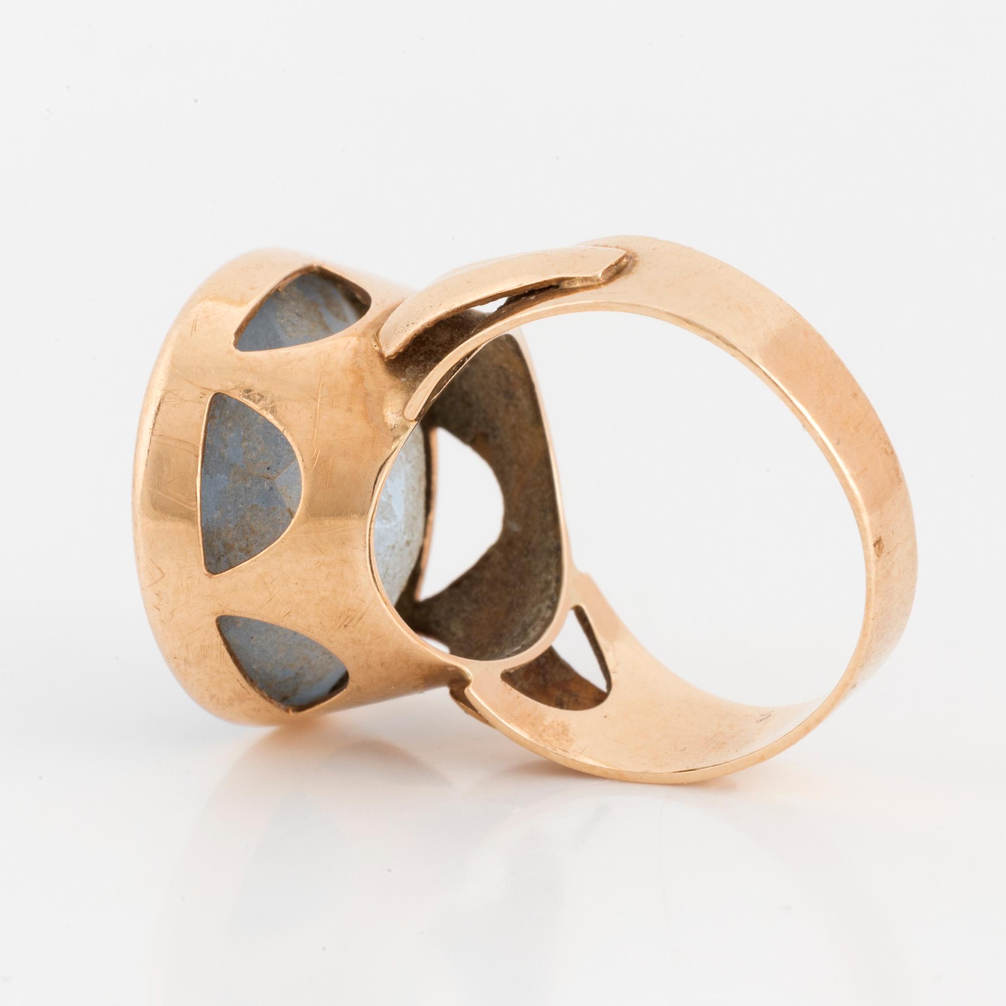 A 14K gold and synthetic blue spinel ring.