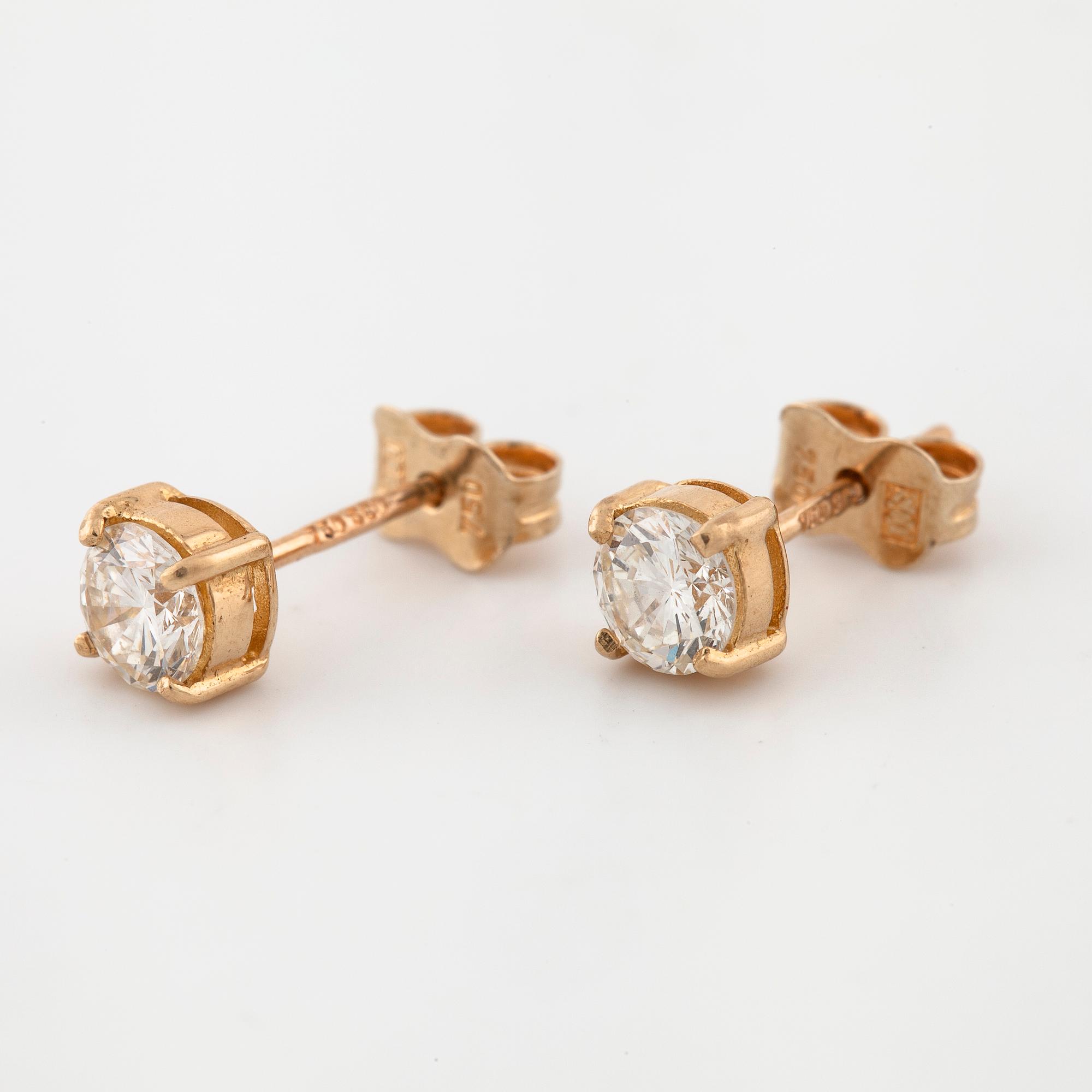 A pair of brilliant cut diamond earrings.