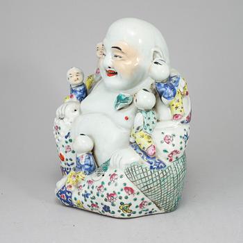 A large famille rose porcelain figure of a buddha with children, 20th century.