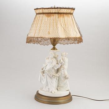 A parian and metall table lamp, first half of the 20th century.