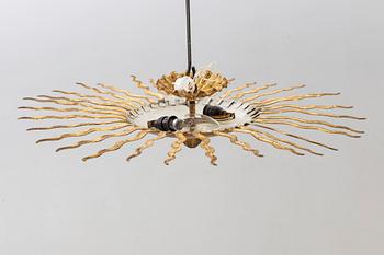 A ceiling lamp in the shape of the sun. Mid 20th century.