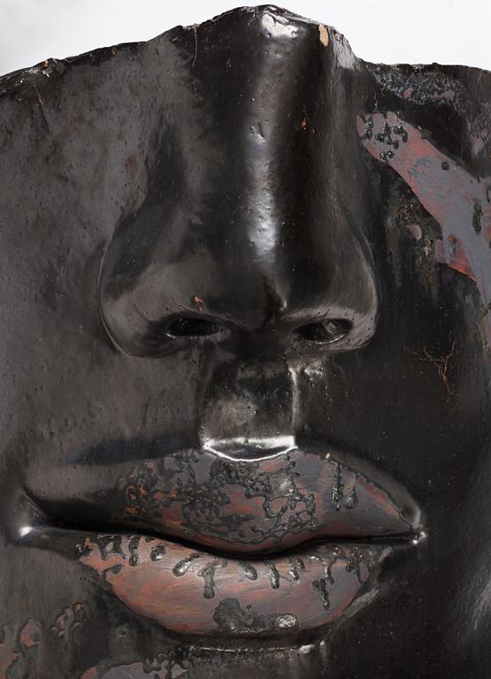 Hertha Hillfon, a black glazed stoneware wall sculpture in two parts of a face and a sky, executed in her own studio, Stockholm 1960s.