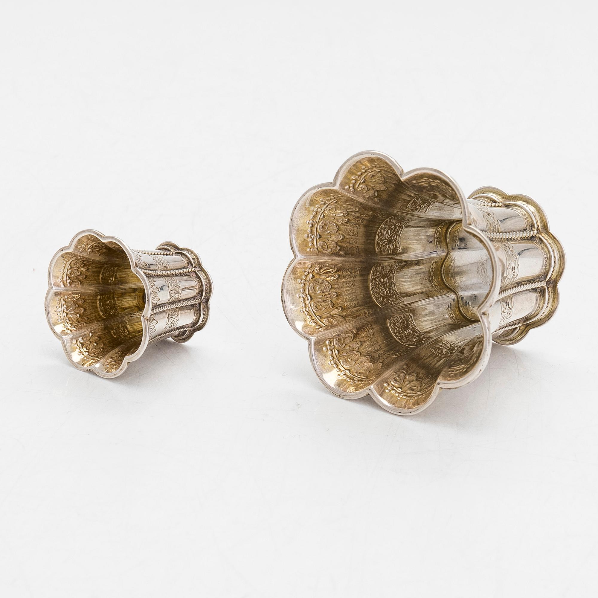 Two miniature beakers and a butter pan, Copenhagen, 1950s, and a silver-plated bottle coaster.