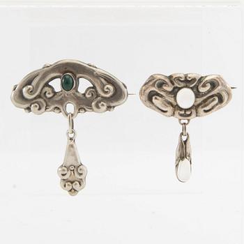 Brooches, 2 pieces, Art Nouveau, early 20th century, pewter, moonstone, and green stone.