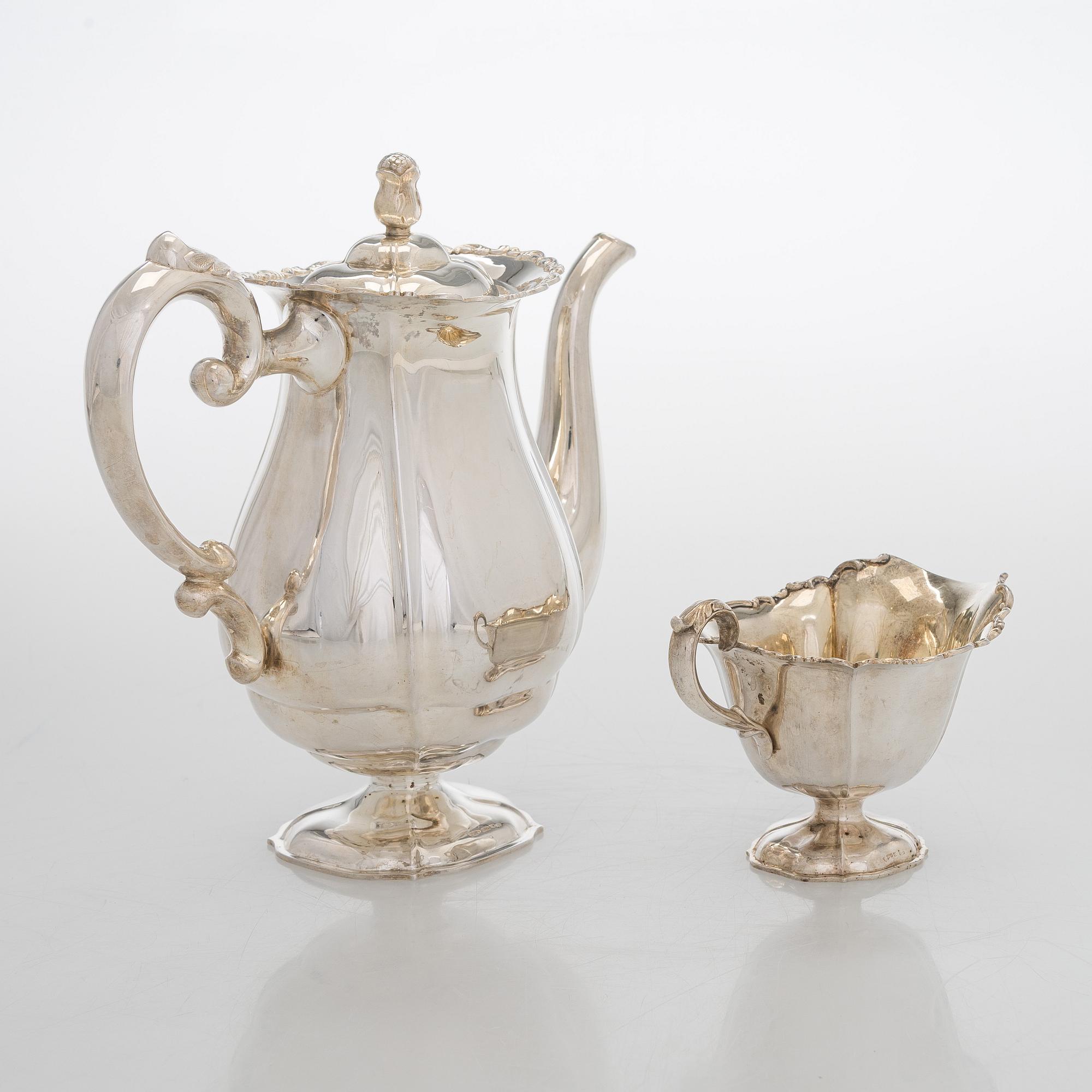A silver coffee pot, sugar bowl, cream jug, and sugar tongs, Finland 1926-49.